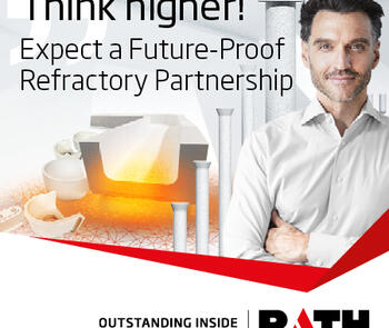 a dark-haired man with his arms crossed stand beside a glass refractory and replacement parts from rath